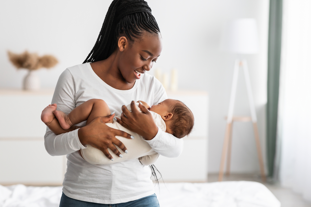 A mom cradles her infant