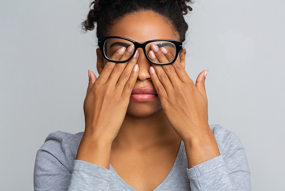 Woman with diabetes and eye complications rubs her eyes