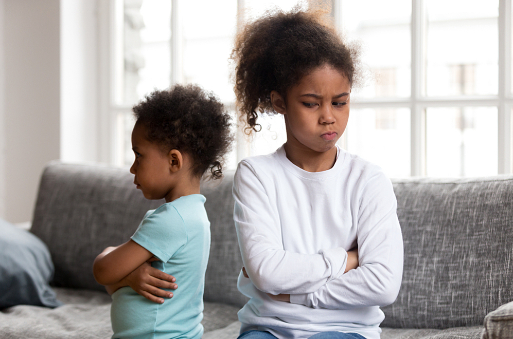 A young girl with type 1 diabetes argues with her younger sister