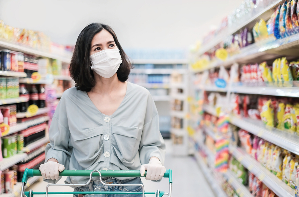 Woman with type 1 diabetes shopping at the grocery store with a mask and gloves during COVID-19.