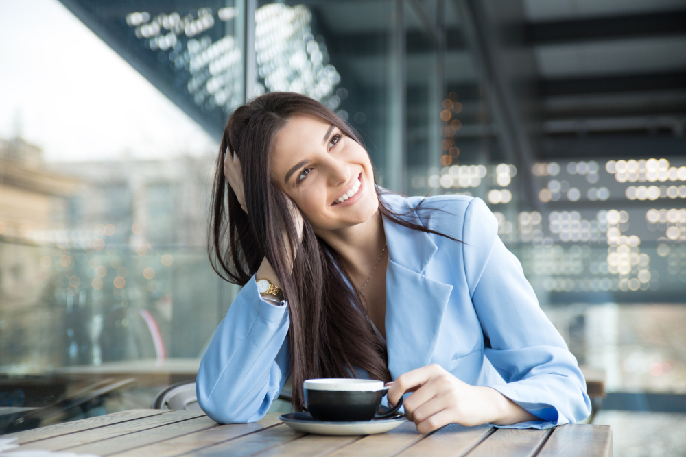 A woman drinks a cup of coffee.
