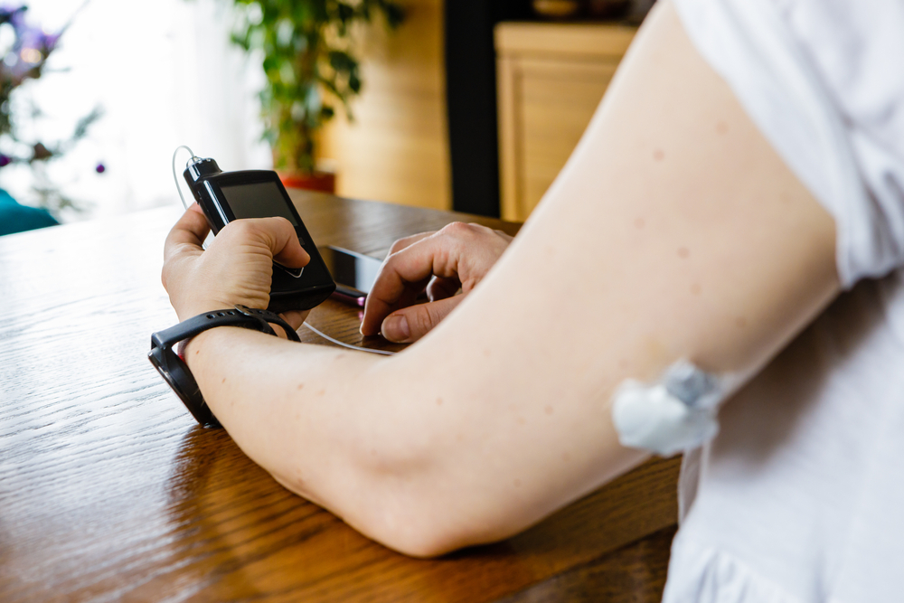 A person programs their insulin pump.