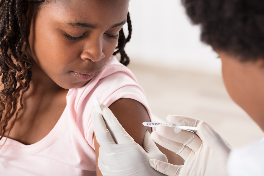 A girl receives an injection of insulin.