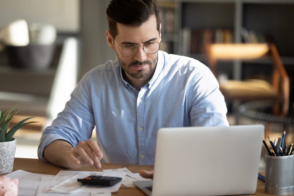Man working on a laptop at his desk.