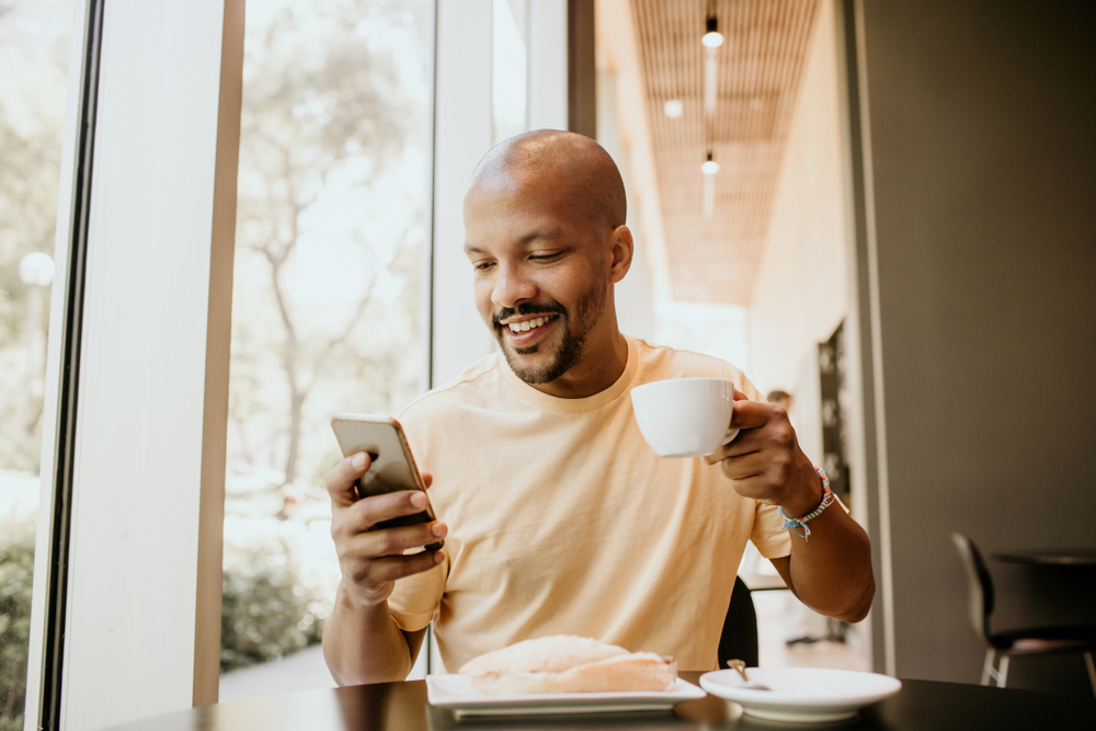 A man checks his blood glucose levels on his cellphone