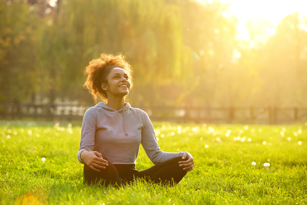 A woman sitting in a field