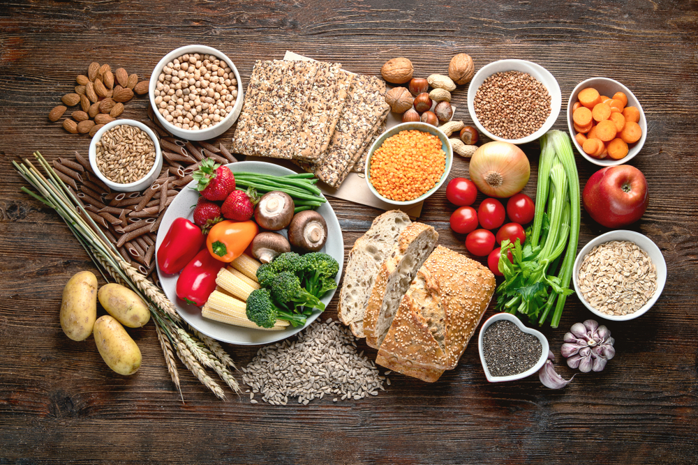 Table of healthy food, including bread with gluten, seen from above,