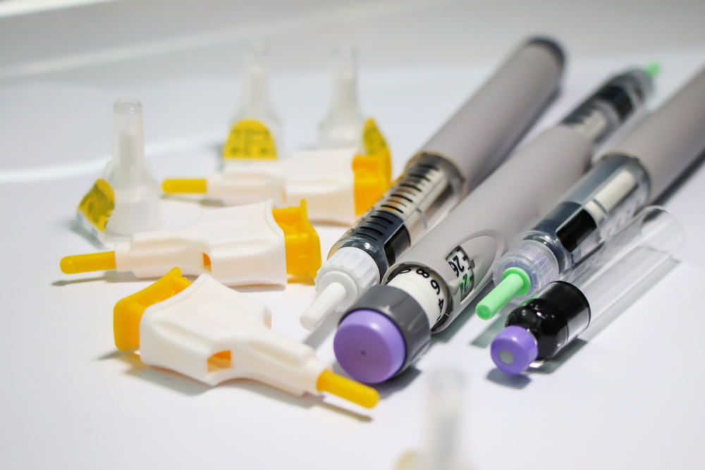 Several insulin pens and diabetes needles.