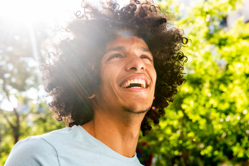 A man smiling outside.