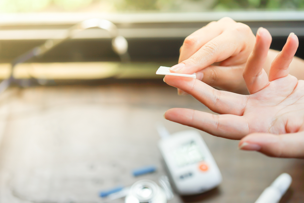 Person holding a piece of gauze to their fingertip