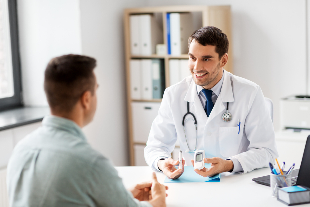 Man discussing diabetes goals and concerns while doctor provides recommendations