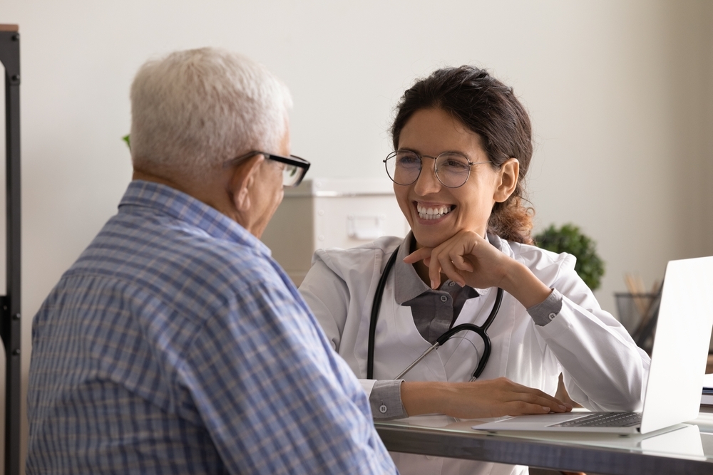 An older adult meets with a doctor