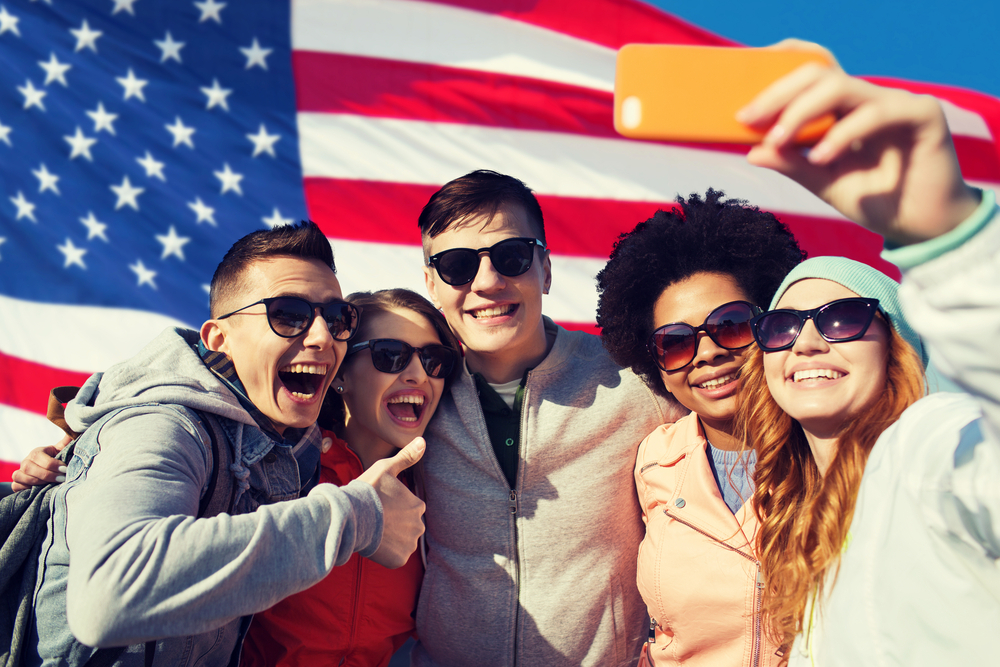 Young adults taking a group selfie.