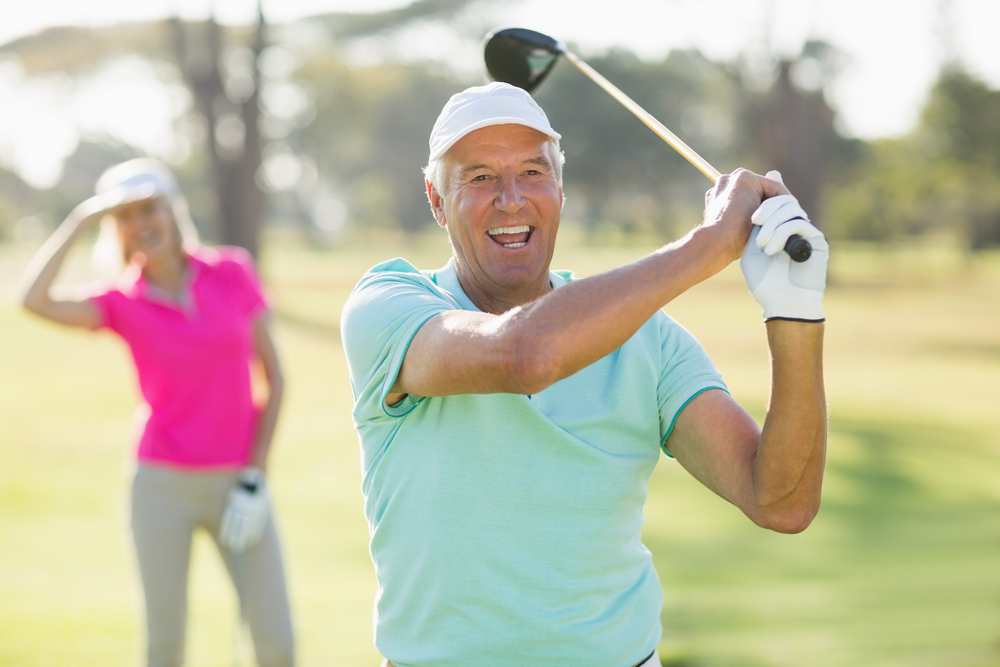 An older man plays golf