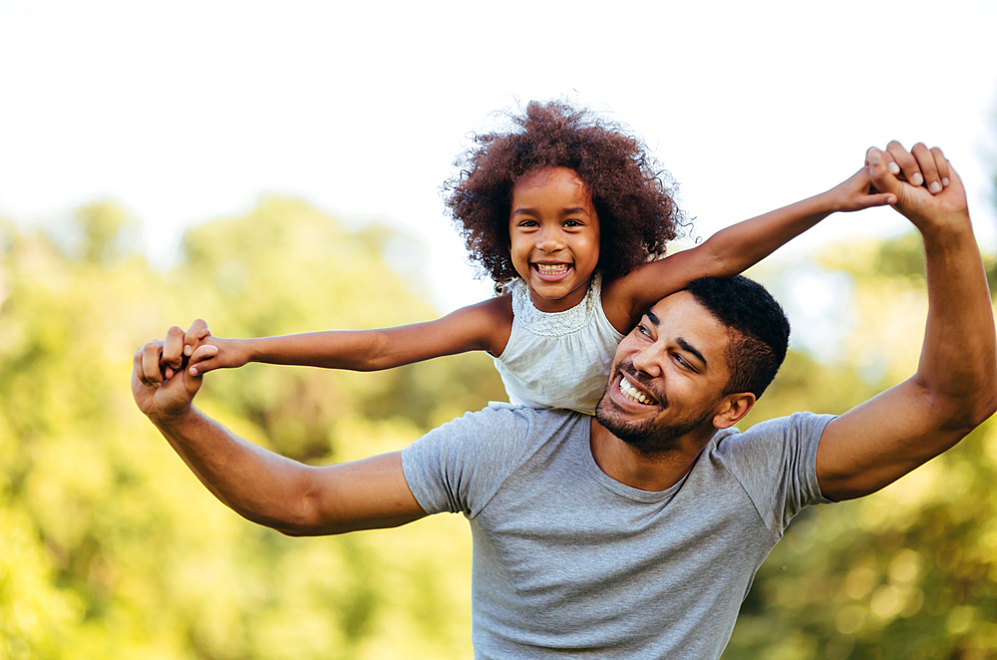 A father plays with his daughter, who has type 1 diabetes, while enjoying the outdoors