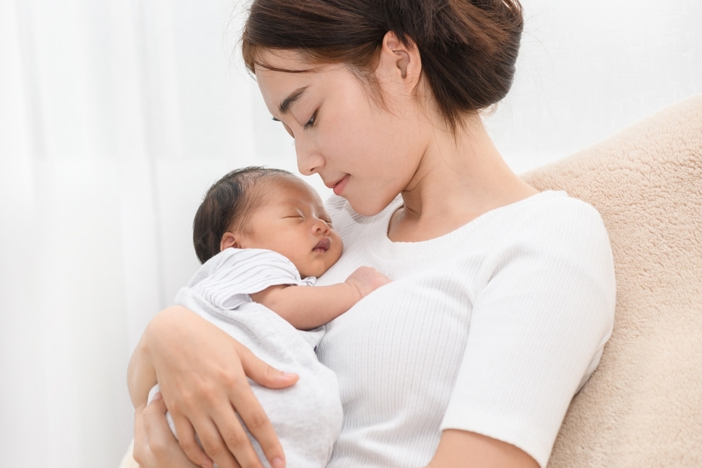 A mother cuddles her baby