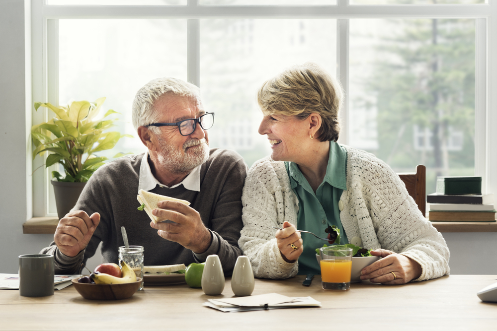 An older couple eating lunch together