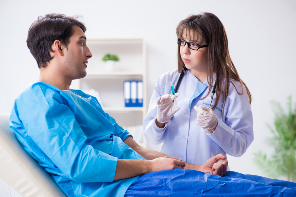 Man discussing insulin injection with his doctor
