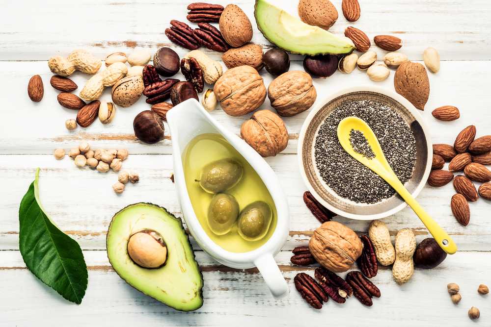 An assortment of oils and nuts rich in monounsaturated fat.