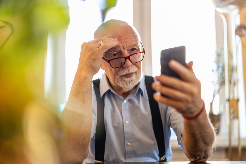 Man troubleshooting CGM problem on his phone