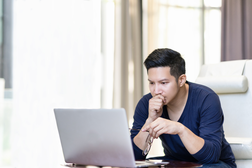 Young professional sitting in front of a laptop.