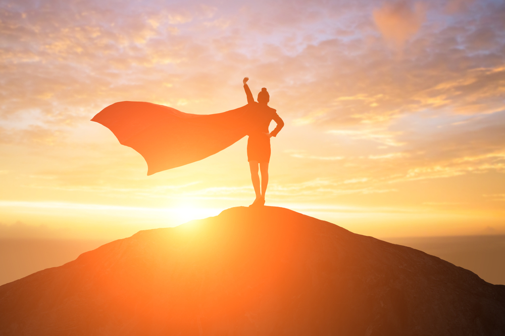 A silhouette of a woman wearing a cape