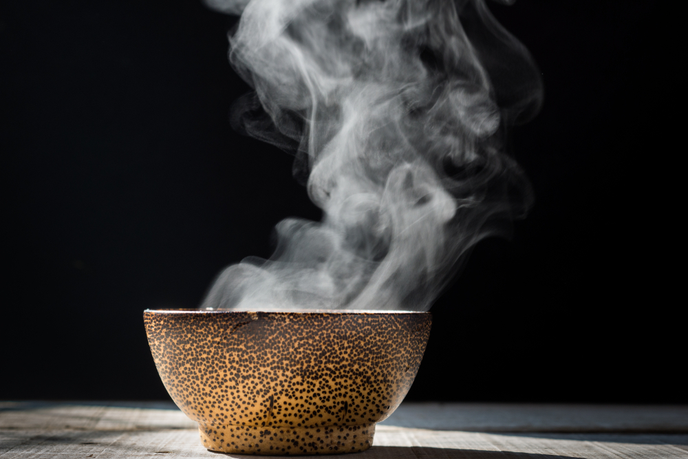 A steaming hot bowl of soup.