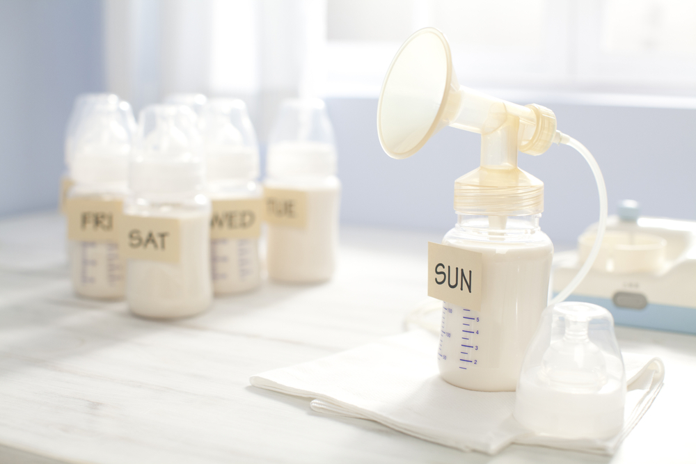 Bottles of pumped breast milk on a table