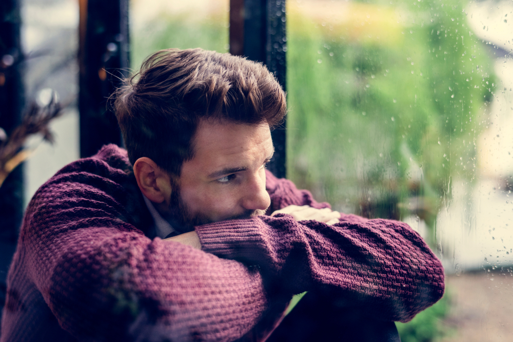 A man looking out the window