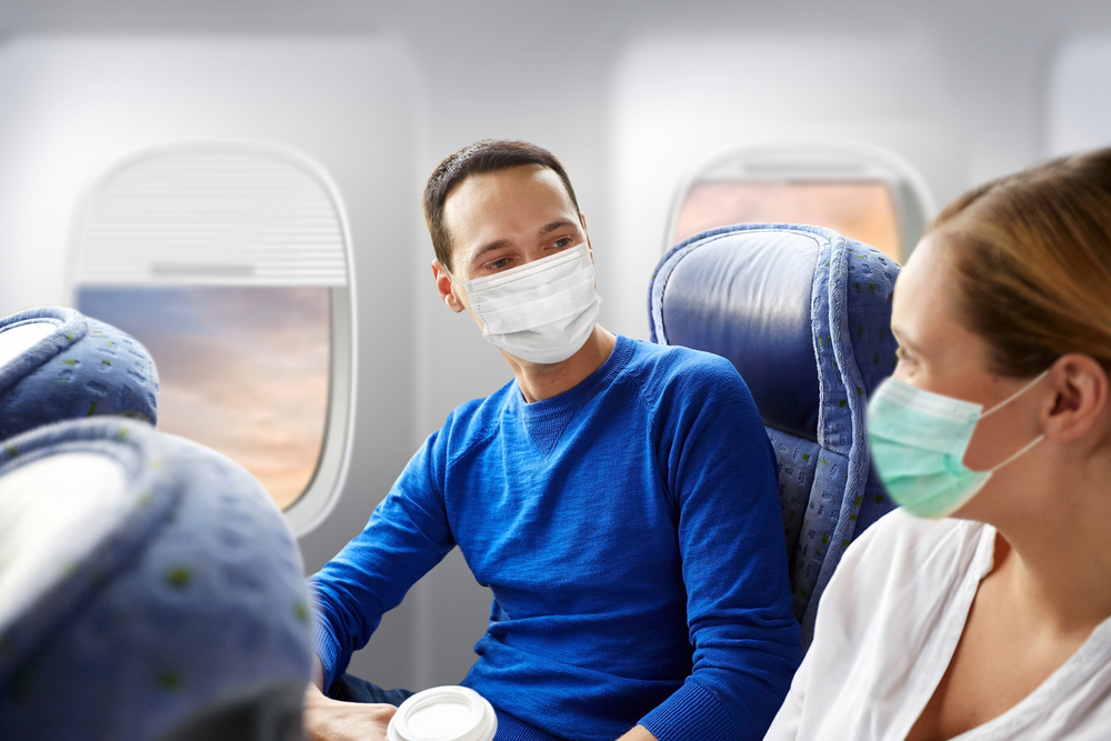 People wearing masks on an airplane