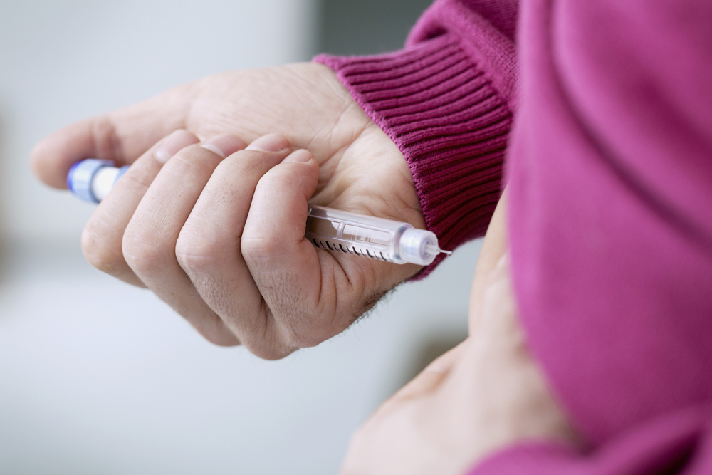 A person using an insulin pen.
