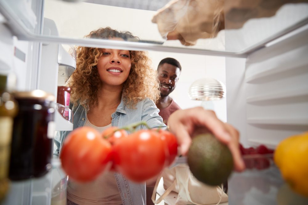 Woman reaching for an avocado