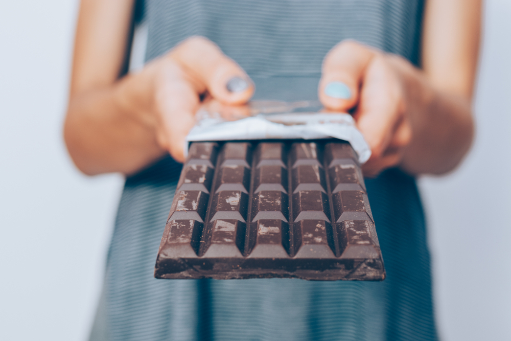 A woman holding a chocolate bar