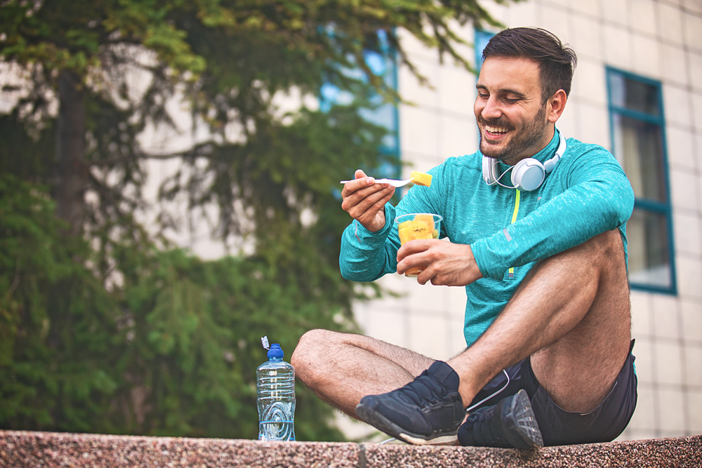 A man eating a post-workout snack