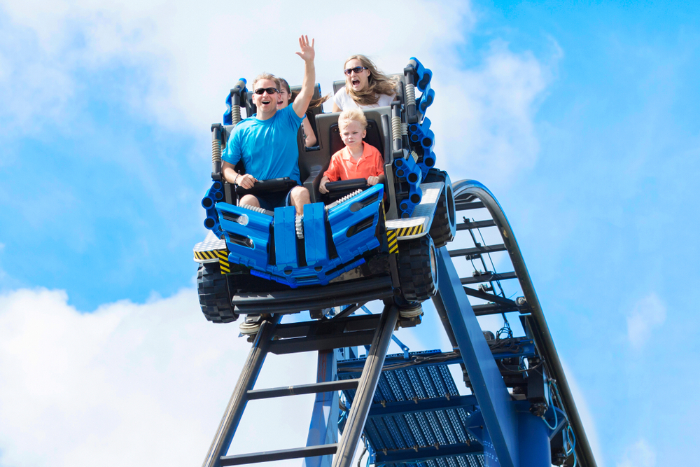 A family rides a roller coaster.