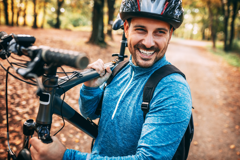 Man holding a bicycle.