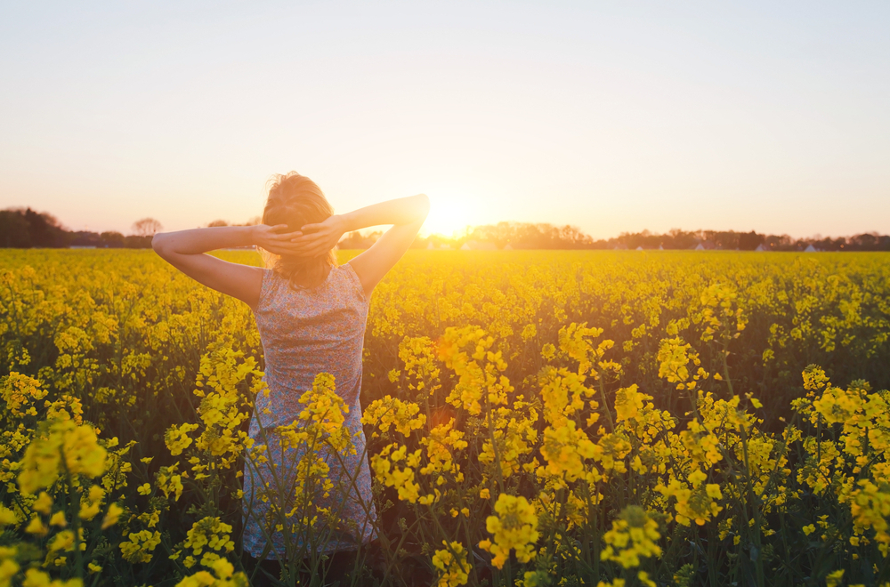 Woman with diabetes walks through field before dinnertime
