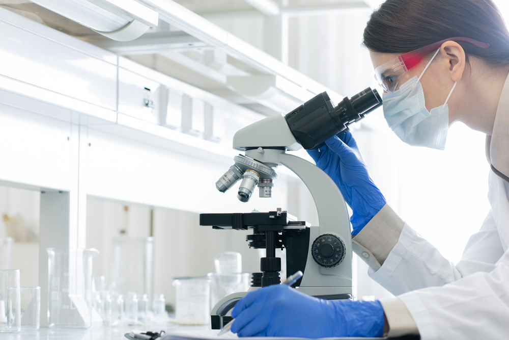 A scientist using a microscope