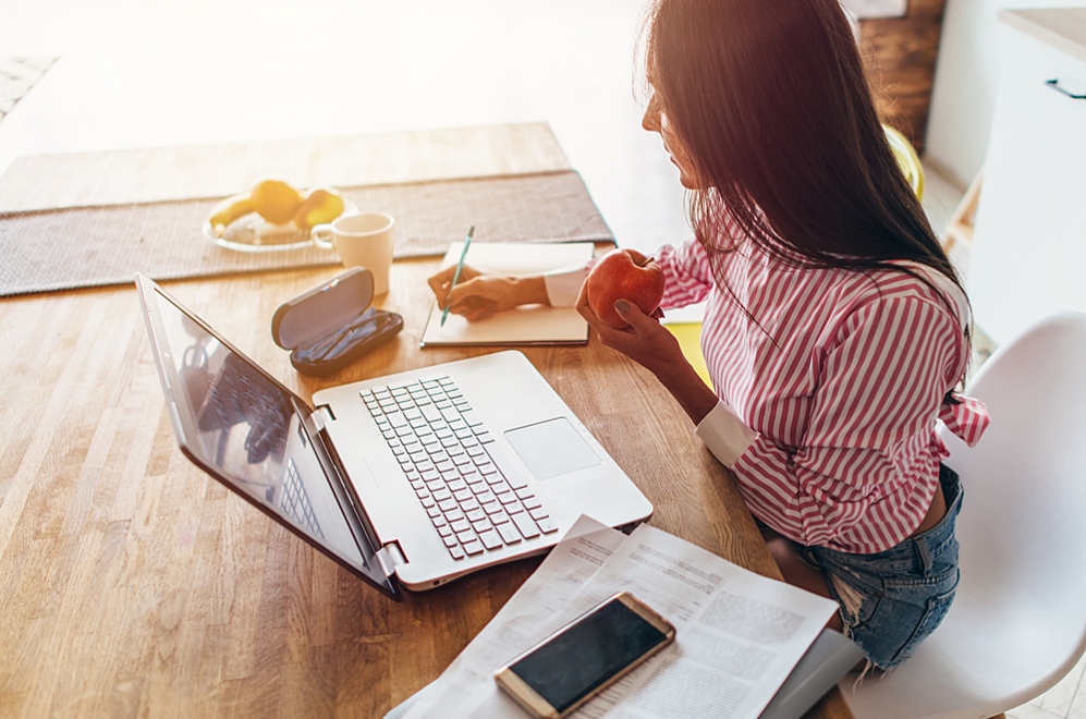 Woman with T1D working at her desk and calculating costs