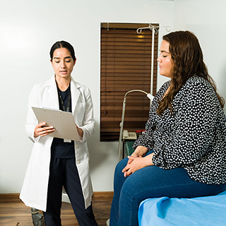 Hispanic woman speaking with her doctor on diabetes treatments